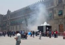 Normalistas de Ayotzinapa lanzan petardos contra fachada de Palacio Nacional